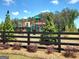 Community playground seen behind a black wooden fence and manicured landscaping at 143 Oakchase Park Ln, Hampton, GA 30228
