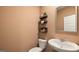 This powder room features a modern sink, toilet, and shelving with stylish decor at 143 Oakchase Park Ln, Hampton, GA 30228