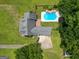 Aerial shot showcases the home's roof, driveway, and backyard pool area, surrounded by mature trees at 10215 Creel Rd, Chattahoochee Hills, GA 30213
