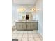 Well-lit bathroom featuring a double vanity with granite countertops and neutral tile flooring at 10215 Creel Rd, Chattahoochee Hills, GA 30213