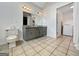 Functional bathroom with a double vanity, granite countertops, and convenient access to laundry at 10215 Creel Rd, Chattahoochee Hills, GA 30213