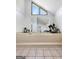 Elegant bathroom showcasing a large soaking tub with tiled surround and decorative accents at 10215 Creel Rd, Chattahoochee Hills, GA 30213