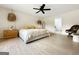 Serene bedroom with neutral tones, a ceiling fan, and a view to an ensuite bathroom at 10215 Creel Rd, Chattahoochee Hills, GA 30213
