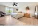 Spacious bedroom featuring a large window, a ceiling fan, and hardwood-style floors at 10215 Creel Rd, Chattahoochee Hills, GA 30213