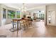Spacious dining area adjacent to the living room, featuring hardwood floors and plenty of natural light at 10215 Creel Rd, Chattahoochee Hills, GA 30213