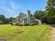 Charming home with stone accents, lush landscaping, well manicured yard, and a long driveway at 10215 Creel Rd, Chattahoochee Hills, GA 30213