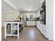 Well-lit kitchen with white cabinetry, stainless steel appliances, and a center island, perfect for cooking and dining at 10215 Creel Rd, Chattahoochee Hills, GA 30213