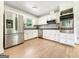 Updated kitchen features stainless steel appliances, white cabinets, and ample counter space for meal preparation at 10215 Creel Rd, Chattahoochee Hills, GA 30213