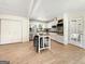 Bright kitchen with white cabinets, stainless steel appliances, and a functional island with seating at 10215 Creel Rd, Chattahoochee Hills, GA 30213