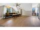Upstairs living room with a fan, hardwood floors, sofa, and natural light from two windows at 10215 Creel Rd, Chattahoochee Hills, GA 30213