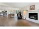 Open-concept living space with a stone fireplace, seamlessly connecting the kitchen, dining, and living areas at 10215 Creel Rd, Chattahoochee Hills, GA 30213