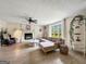 Stylish living room with a stone fireplace, comfortable seating, and natural light, creating a relaxing atmosphere at 10215 Creel Rd, Chattahoochee Hills, GA 30213