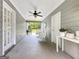 Outdoor patio with gray siding, white furniture, a ceiling fan, and view of a green yard at 10215 Creel Rd, Chattahoochee Hills, GA 30213