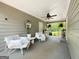 Relaxing outdoor patio with white chairs, decor, and a serene view of the backyard at 10215 Creel Rd, Chattahoochee Hills, GA 30213