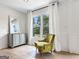 Cozy sitting room with a vintage chair, soft curtains and lots of natural light at 10215 Creel Rd, Chattahoochee Hills, GA 30213
