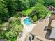 Aerial photo showing the swimming pool and outdoor space nestled between the main house and the barn at 250 Friendship Church Rd, Brooks, GA 30205