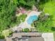Birds eye view of rear yard showcasing large pool, covered patio area, large deck and lush landscaping at 250 Friendship Church Rd, Brooks, GA 30205