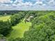 Expansive aerial view showcasing the residence, barn, and sprawling green pastures at 250 Friendship Church Rd, Brooks, GA 30205