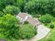 Aerial view of the beautiful home surrounded by mature landscaping and a long drive at 250 Friendship Church Rd, Brooks, GA 30205