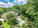 Aerial view showcasing the estate, swimming pool and lush greenery, with the house nestled among mature trees at 250 Friendship Church Rd, Brooks, GA 30205