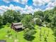 Aerial view of estate featuring pool, outbuildings and a beautiful manicured yard at 250 Friendship Church Rd, Brooks, GA 30205