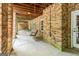Spacious covered back porch with exposed wood ceiling and a charming wooden porch swing at 250 Friendship Church Rd, Brooks, GA 30205