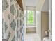 Bathroom featuring a window in the shower, white walls, tile floor, and neutral paint at 250 Friendship Church Rd, Brooks, GA 30205