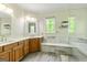 Bathroom featuring a double vanity, quartz countertop, soaking tub, and glass shower at 250 Friendship Church Rd, Brooks, GA 30205