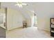 Upstairs bedroom with a chair, carpet, a double door closet, and a window at 250 Friendship Church Rd, Brooks, GA 30205
