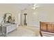 Bedroom with a wooden bed, ceiling fan, carpet, and a gray vanity at 250 Friendship Church Rd, Brooks, GA 30205