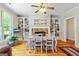 Bright dining room with wood floors, fireplace, built-in shelves, and a ceiling fan at 250 Friendship Church Rd, Brooks, GA 30205