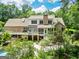 Rear exterior view of home featuring screened porch, large deck, and swimming pool with lush landscaping at 250 Friendship Church Rd, Brooks, GA 30205