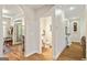 Hallway featuring hardwood floors, an arched doorway, and a view into a powder room at 250 Friendship Church Rd, Brooks, GA 30205