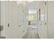 Hallway with wood floors leading to a full bathroom with a shower and tub at 250 Friendship Church Rd, Brooks, GA 30205