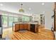 Spacious kitchen featuring wood floors, an island, stainless appliances, and a view to the dining area at 250 Friendship Church Rd, Brooks, GA 30205
