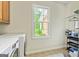 Bright laundry room with tiled floors, a large window, and laundry machines at 250 Friendship Church Rd, Brooks, GA 30205