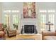Elegant living room with a fireplace, French doors, and hardwood floors at 250 Friendship Church Rd, Brooks, GA 30205