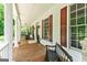 Expansive porch with rocking chairs, and wood floors overlooking the verdant yard at 250 Friendship Church Rd, Brooks, GA 30205