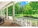 Inviting porch with white columns, wooden floors, and scenic views of landscaped yard at 250 Friendship Church Rd, Brooks, GA 30205