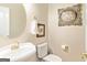 Well-appointed powder room with a pedestal sink, toilet, and decorative artwork at 250 Friendship Church Rd, Brooks, GA 30205