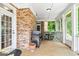 Cozy screened-in porch features brick accents, outdoor seating, and natural light at 250 Friendship Church Rd, Brooks, GA 30205