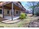 Rear view of a home with a covered patio overlooking a backyard with garden and landscaping at 168 Maple Grove Ter, Peachtree City, GA 30269