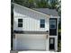 Modern home with mixed materials, including white board and batten siding and a convenient two-car garage at 4832 Station Ln # 12, Union City, GA 30349
