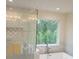 Luxurious bathroom featuring a freestanding tub, a large window, and modern fixtures at 4421 Meadowwood Dr, Loganville, GA 30052
