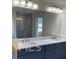 Bathroom showcasing a dual-sink vanity, a large mirror, and modern lighting fixtures at 4421 Meadowwood Dr, Loganville, GA 30052