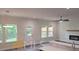 Sunlit living room boasts large windows, a ceiling fan, and fireplace at 4421 Meadowwood Dr, Loganville, GA 30052