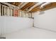 Unfinished basement area with white-painted floor and exposed utilities at 234 Kenilworth Cir, Stone Mountain, GA 30083