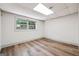 Basement bedroom featuring laminated wood flooring and a large window with tree view at 234 Kenilworth Cir, Stone Mountain, GA 30083
