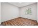 Cozy bedroom featuring sleek laminated wood flooring and natural lighting at 234 Kenilworth Cir, Stone Mountain, GA 30083