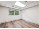Basement bedroom featuring laminated wood flooring and a large window with tree view at 234 Kenilworth Cir, Stone Mountain, GA 30083